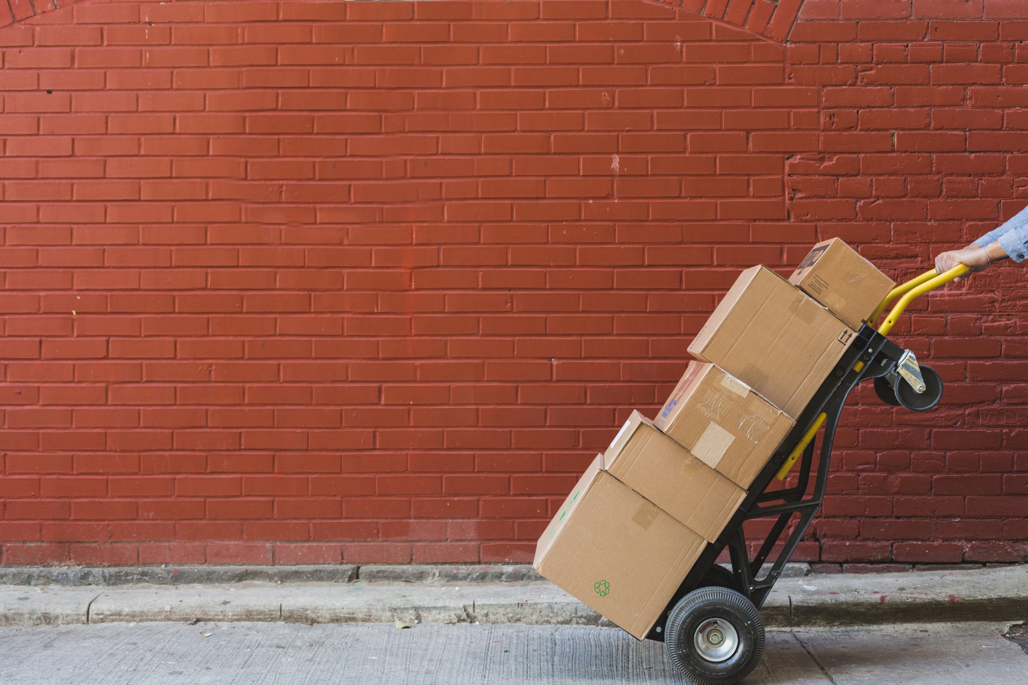 Shipping boxes in front of bricks
