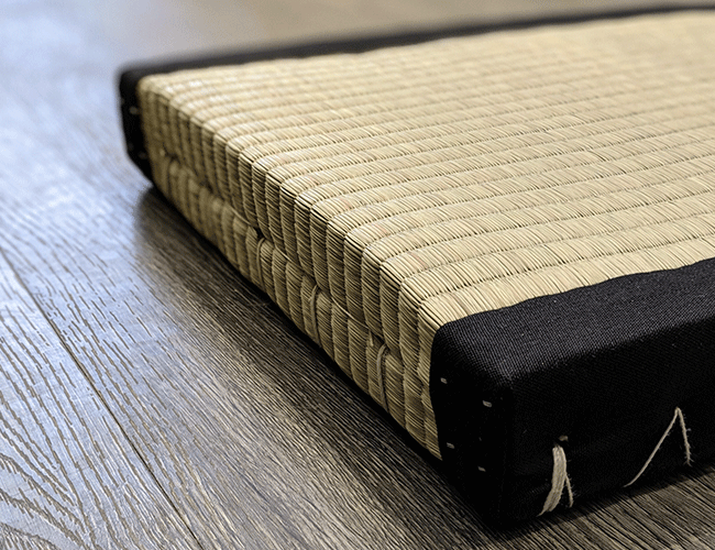 Closeup view of tatami mat showcasing tightly woven mat and black fabric border
