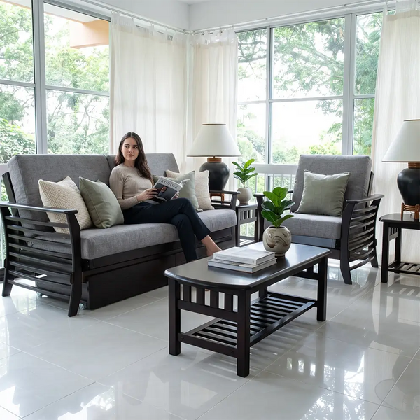 a woman sits on a comfortable and stylish futon in a bright urban style living room. 