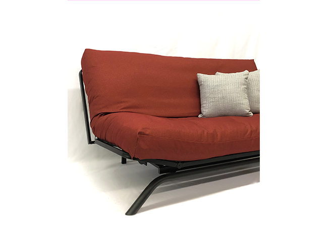 Armless black metal futon with futon mattress and burnt red cover - side view