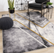 Geometric patterned Soho area rug with grey, black and gold tones
