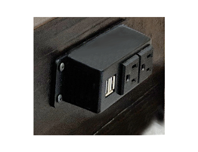 Closeup view of plugin power and USB capability on side of bed